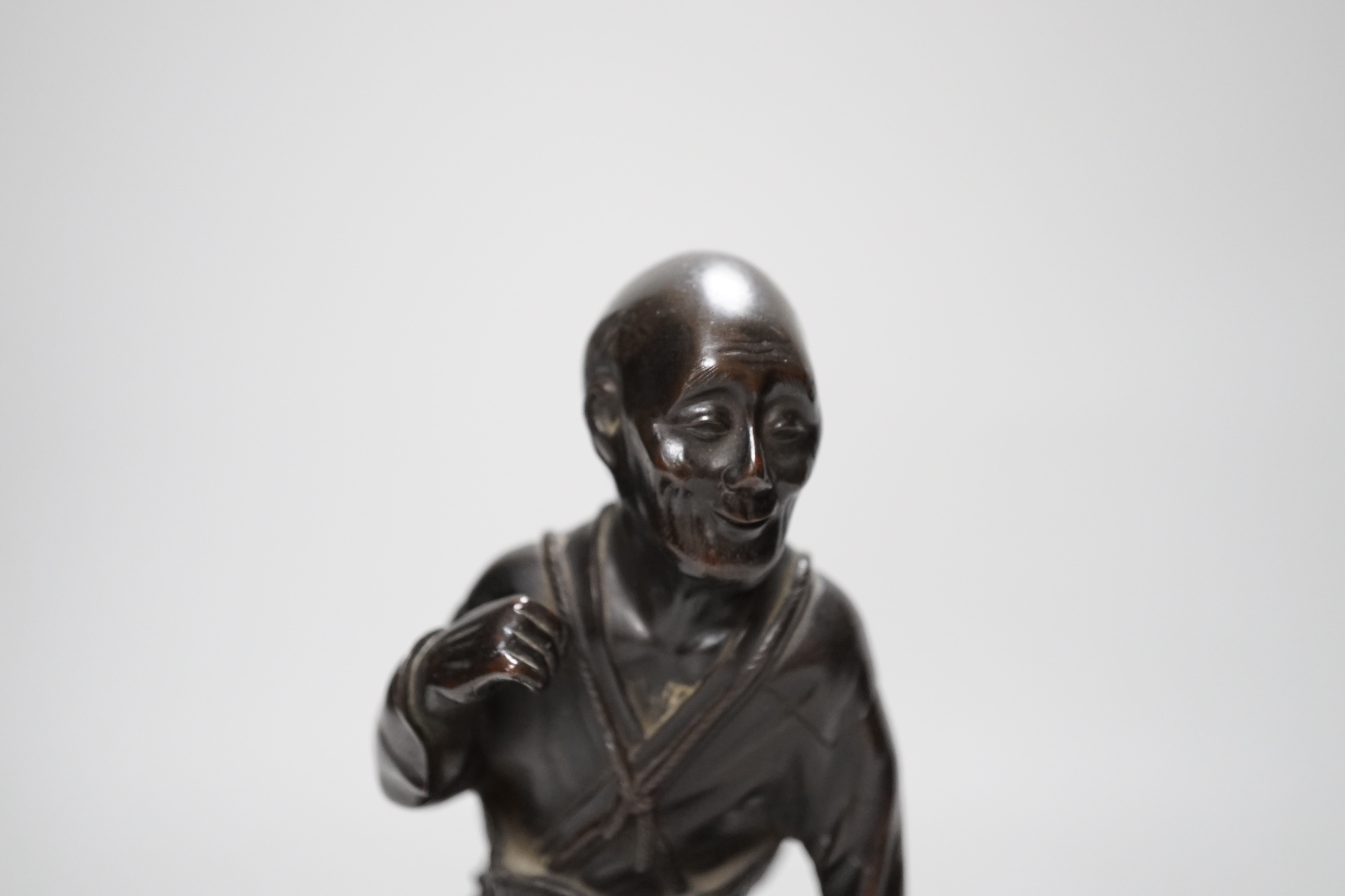 A Japanese bronze figure of an elder, 19th century, 23cm high